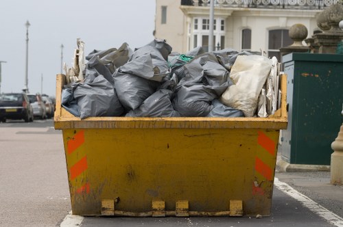 Collection crew sorting commercial bins in Colindale street